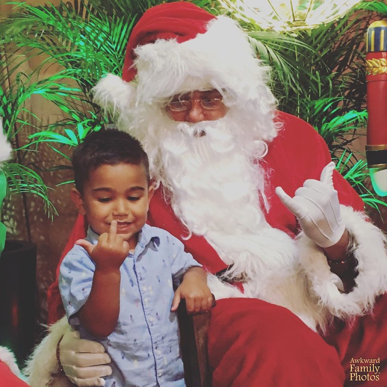 My son was trying to make a Shaka with Santa when the picture was take.jpeg